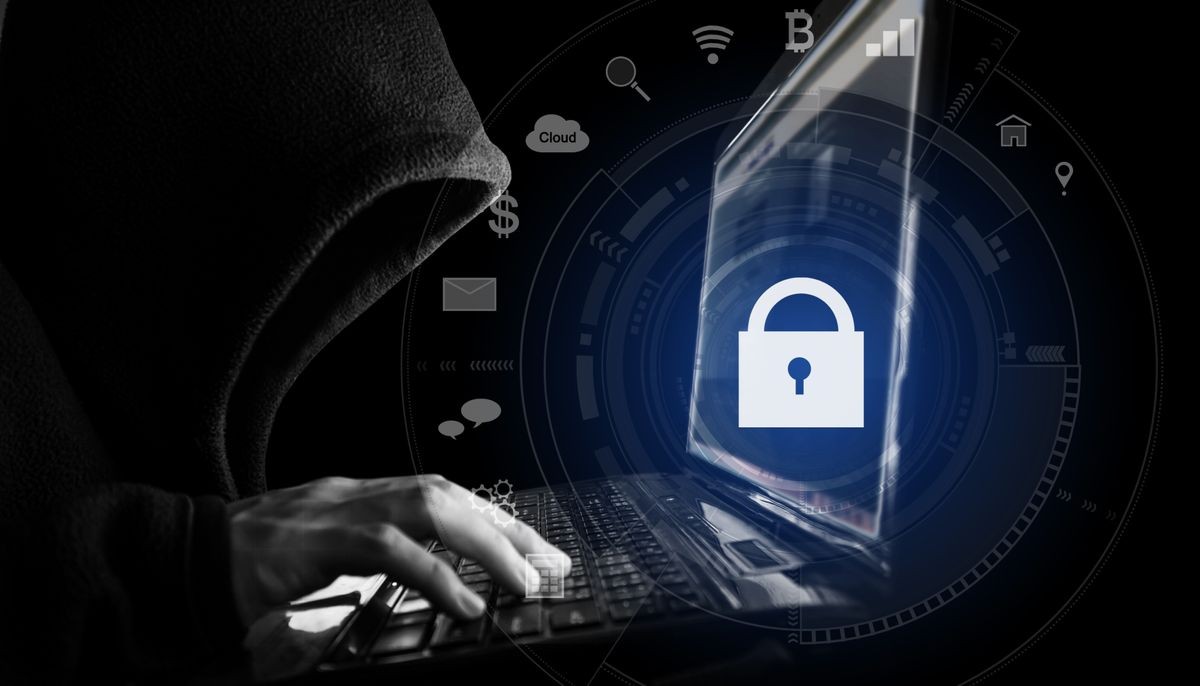 Internet network security system. Hacker in black hoodie using computer laptop and technology lock and application icons